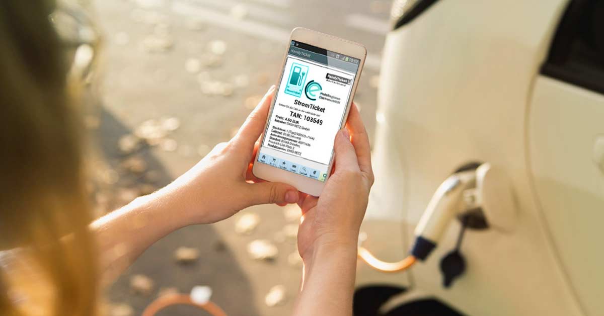 Payment at charging stations Contributing photo: Woman uses an electricity ticket on her smartphone to charge her e-car