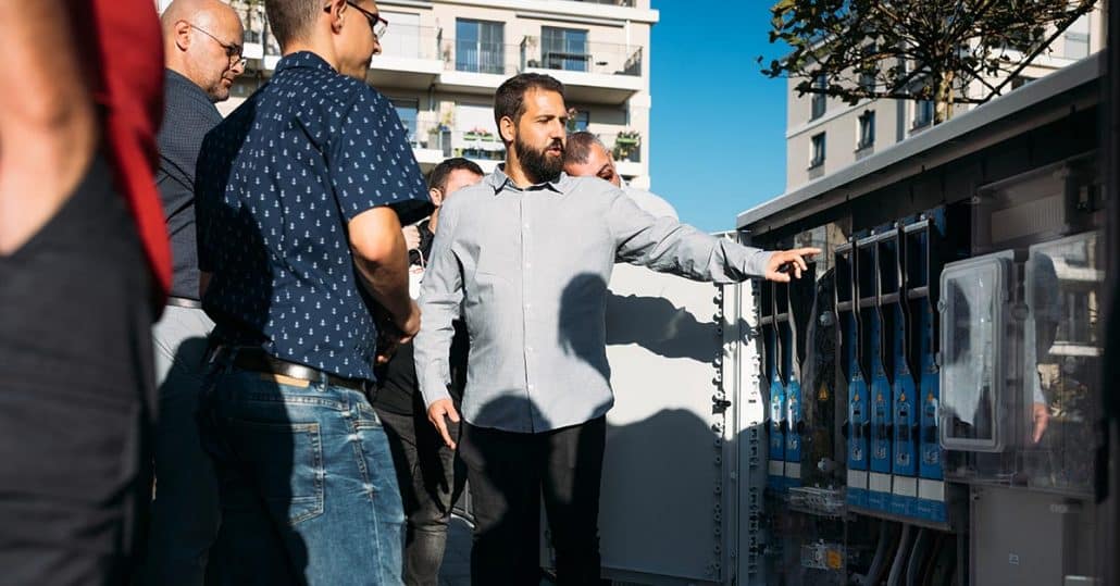 Transducer cabinet with speakers and a group getting something explained